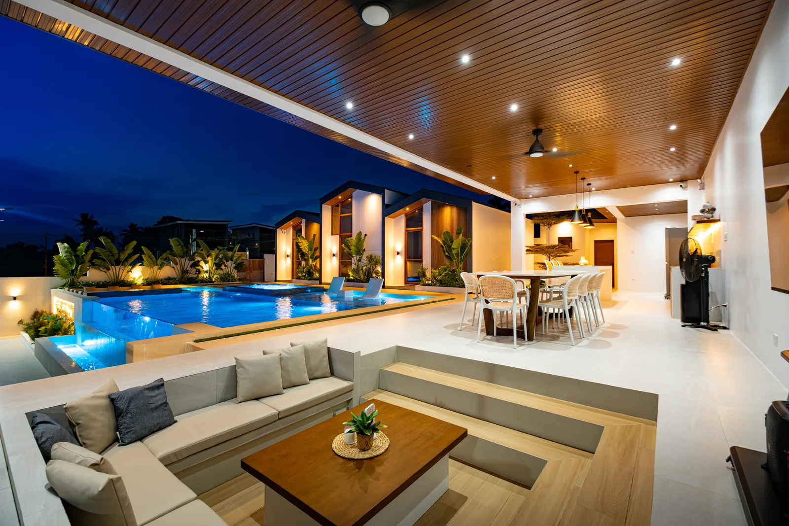 Nighttime view of the pool, villas, gazebo, and sunken lounge at The Kasiden Private Resort.