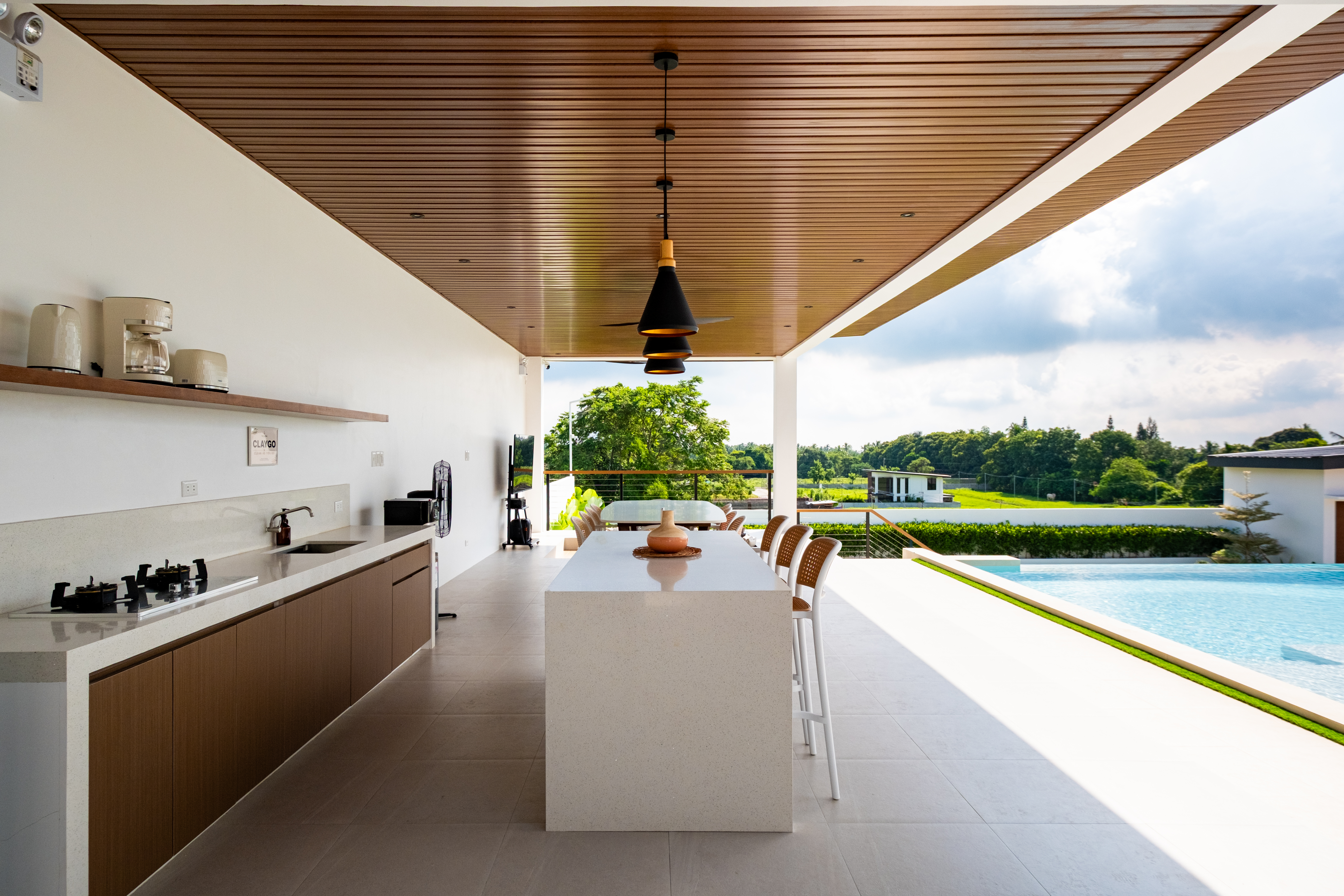 Open-air kitchen and dining pavilion overlooking the infinity pool and surrounding nature at The Kasiden Private Resort in Alfonso, Cavite.