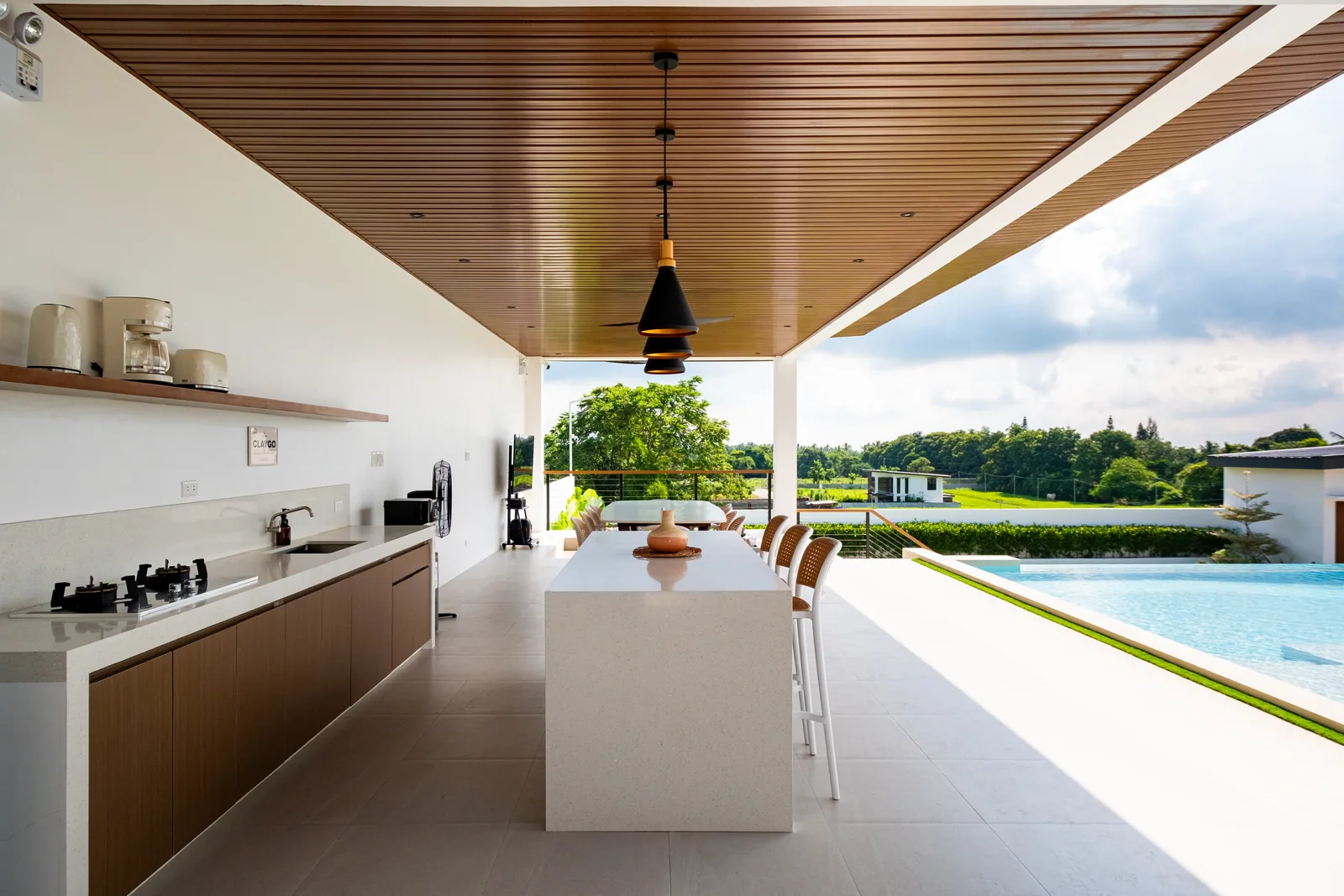Open-air kitchen and dining pavilion overlooking the infinity pool and surrounding nature at The Kasiden Private Resort in Alfonso, Cavite.