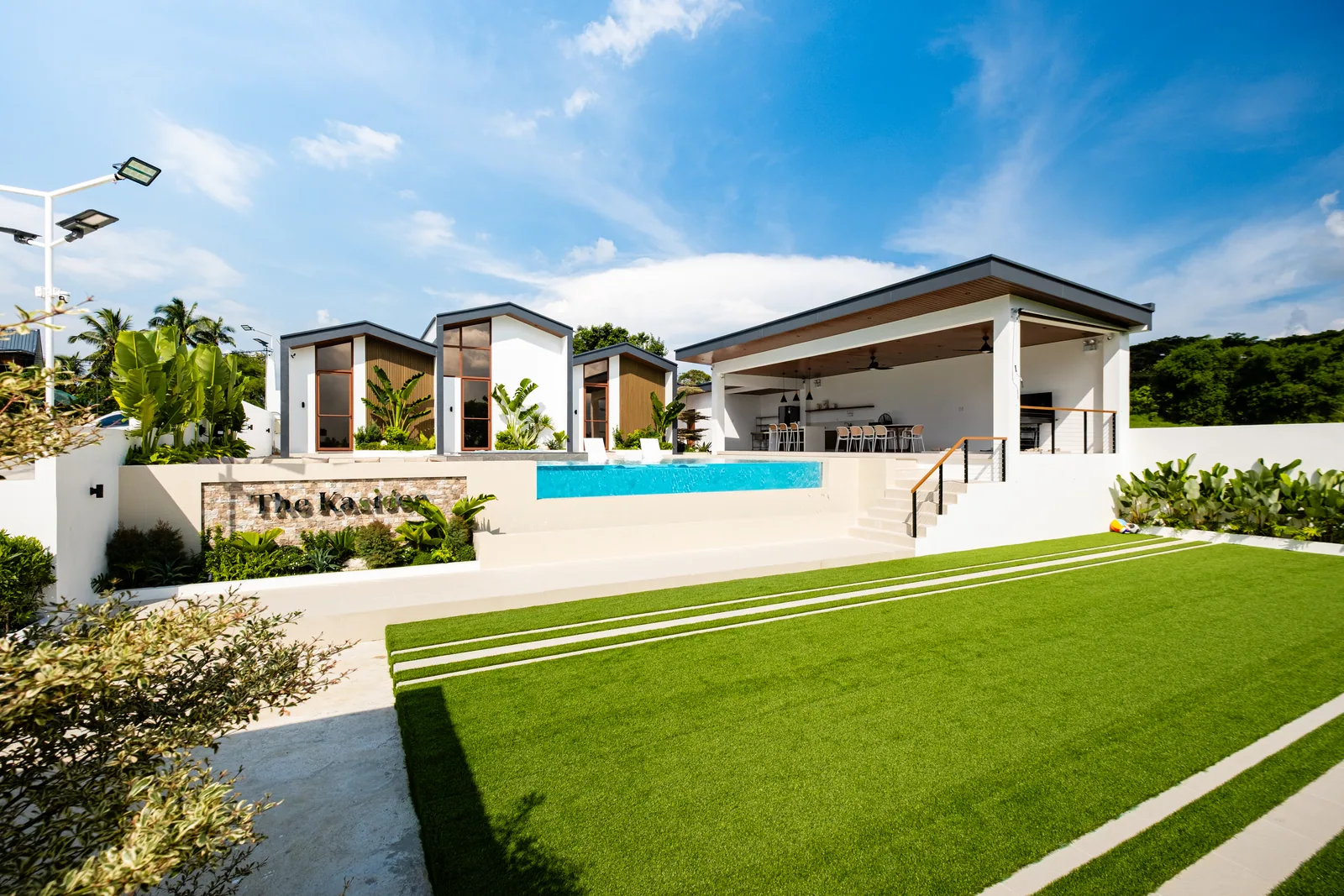 Private resort in Alfonso Cavite featuring open grounds, infinity pool, gazebo, and modern villas.