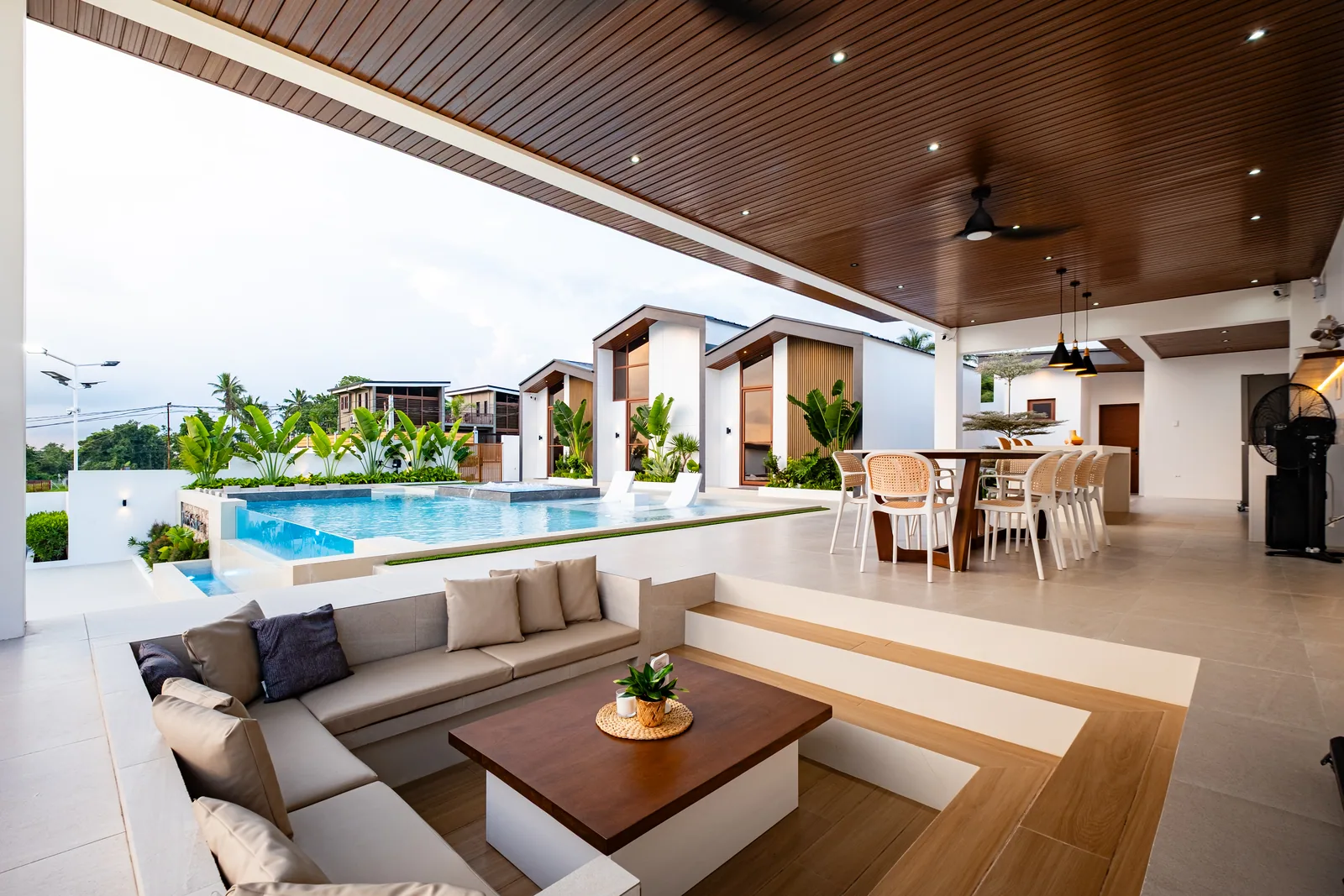 Sunken lounge beside the infinity pool featuring comfortable seating, outdoor entertainment space, and views of the villas at The Kasiden Private Resort.