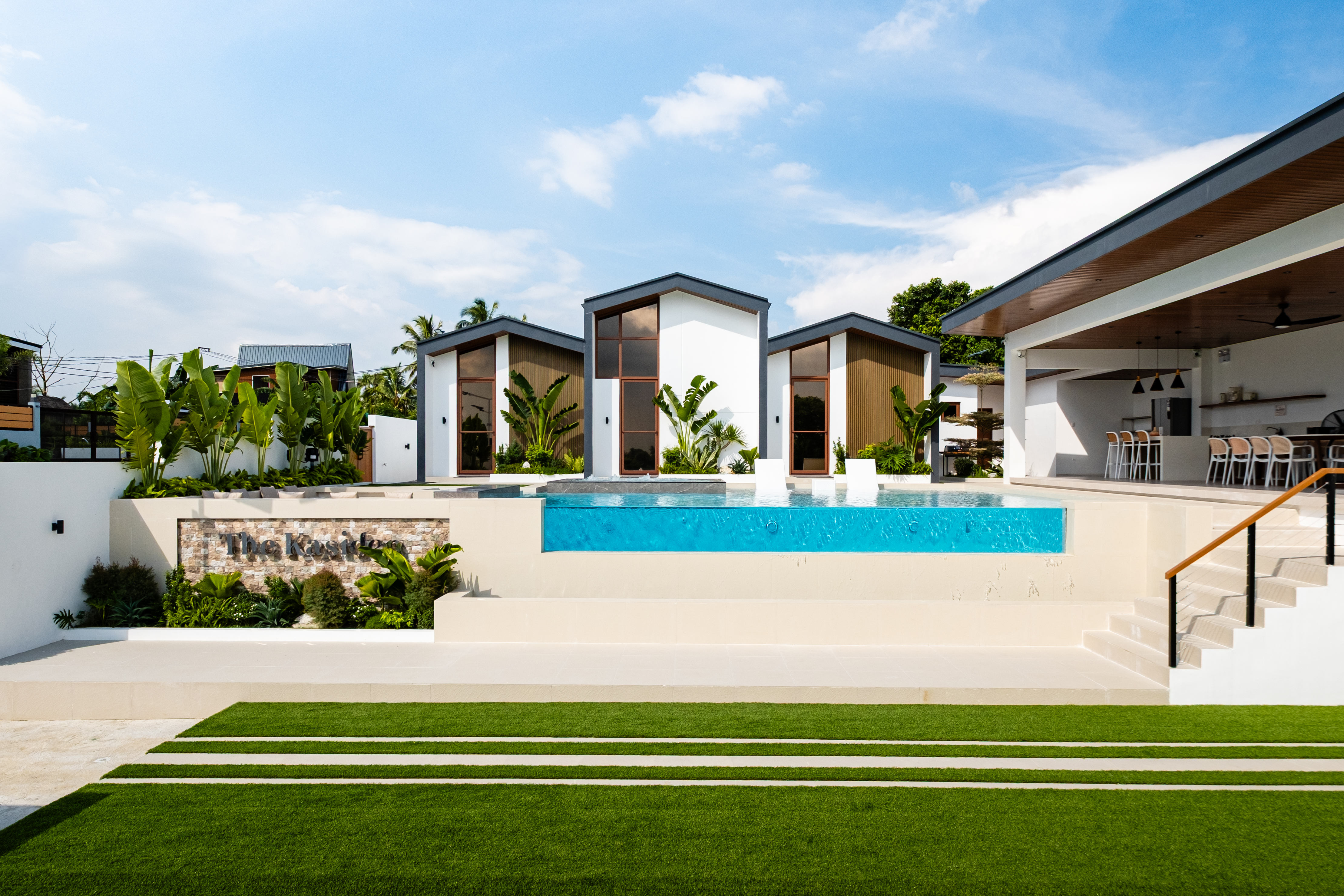 Front view of The Kasiden Private Resort with infinity pool and modern villas.