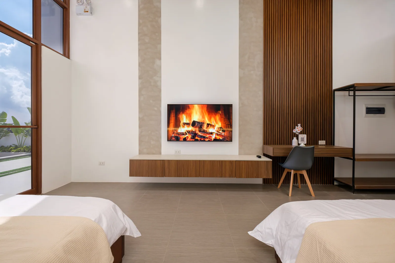 Bright and spacious family suite with two king-size beds, smart TV, workspace, and high-ceiling design at The Kasiden Private Resort.