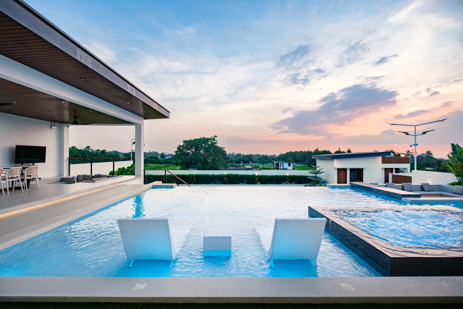 Sunset view over the infinity pool and jacuzzi at The Kasiden Private Resort.