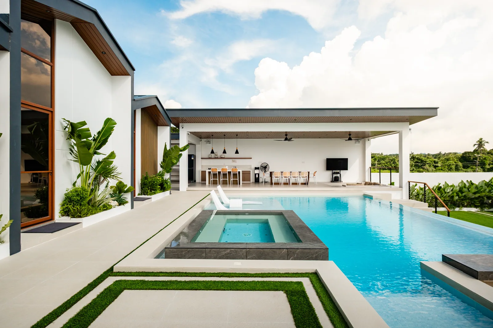 Infinity pool with the open-air gazebo and dining pavilion in the background.
