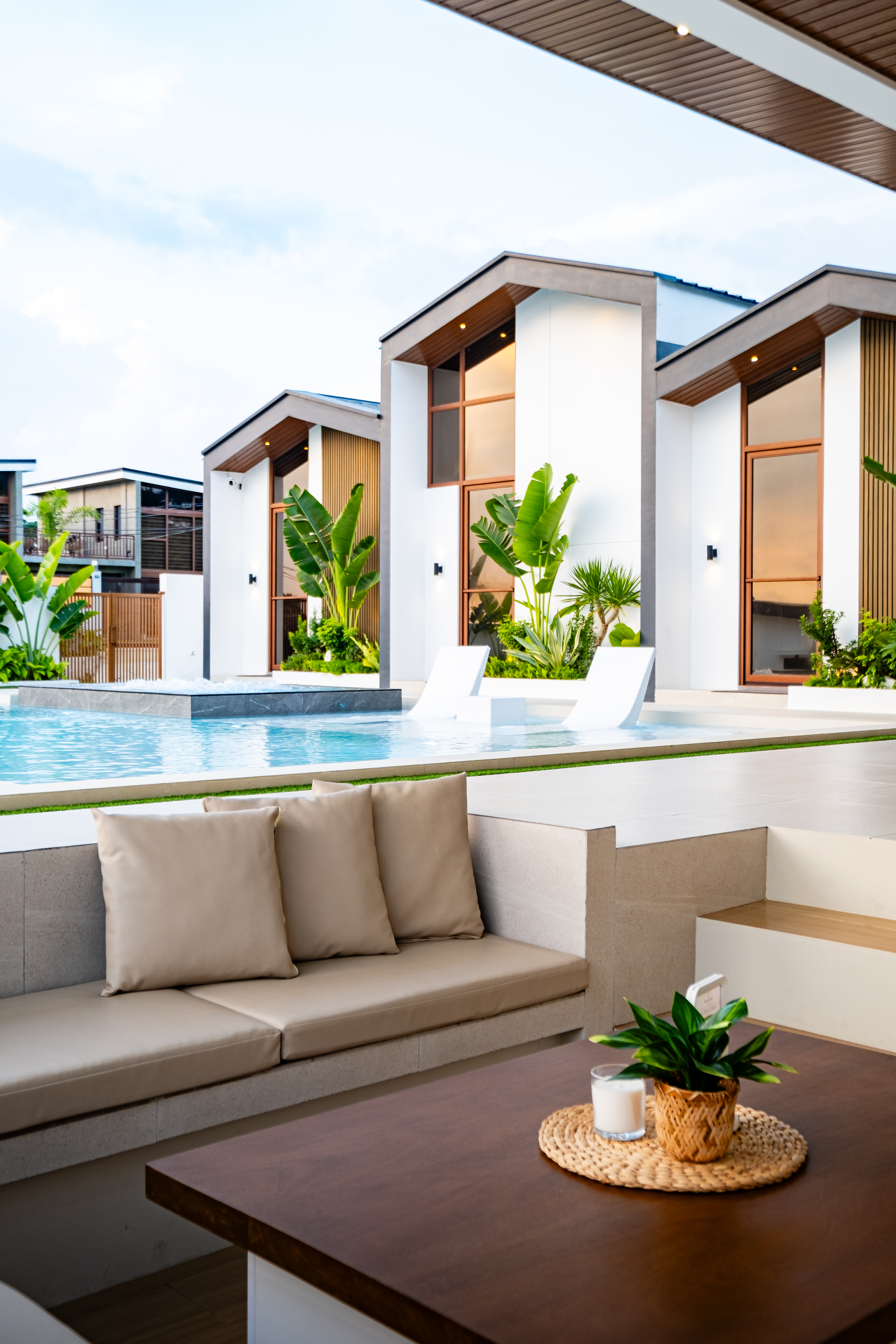 Sunken lounge beside the infinity pool featuring comfortable seating, outdoor entertainment space, and views of the villas at The Kasiden Private Resort.
