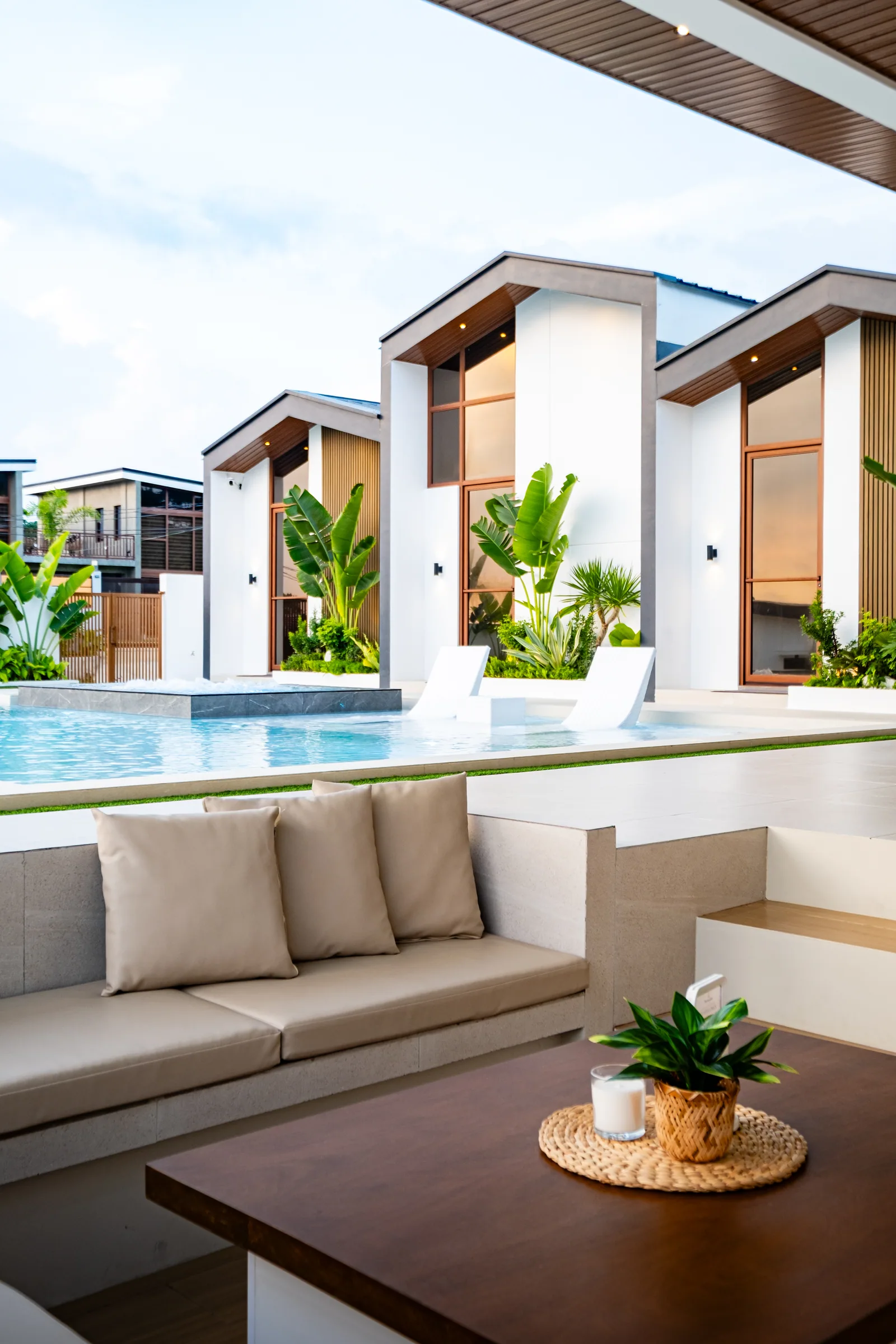 Sunken lounge beside the infinity pool featuring comfortable seating, outdoor entertainment space, and views of the villas at The Kasiden Private Resort.