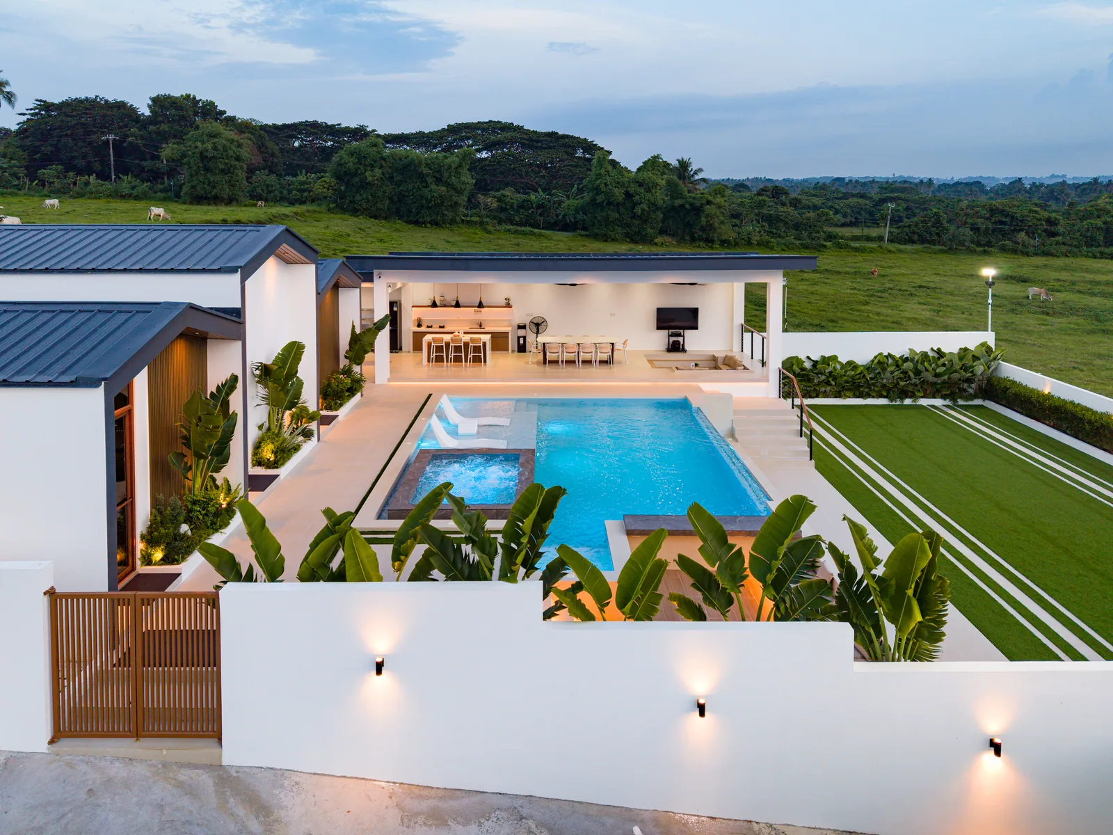 Aerial view of The Kasiden Private Resort featuring the infinity pool, jacuzzi, outdoor dining area, landscaped grounds, and scenic countryside surroundings in Alfonso, Cavite.
