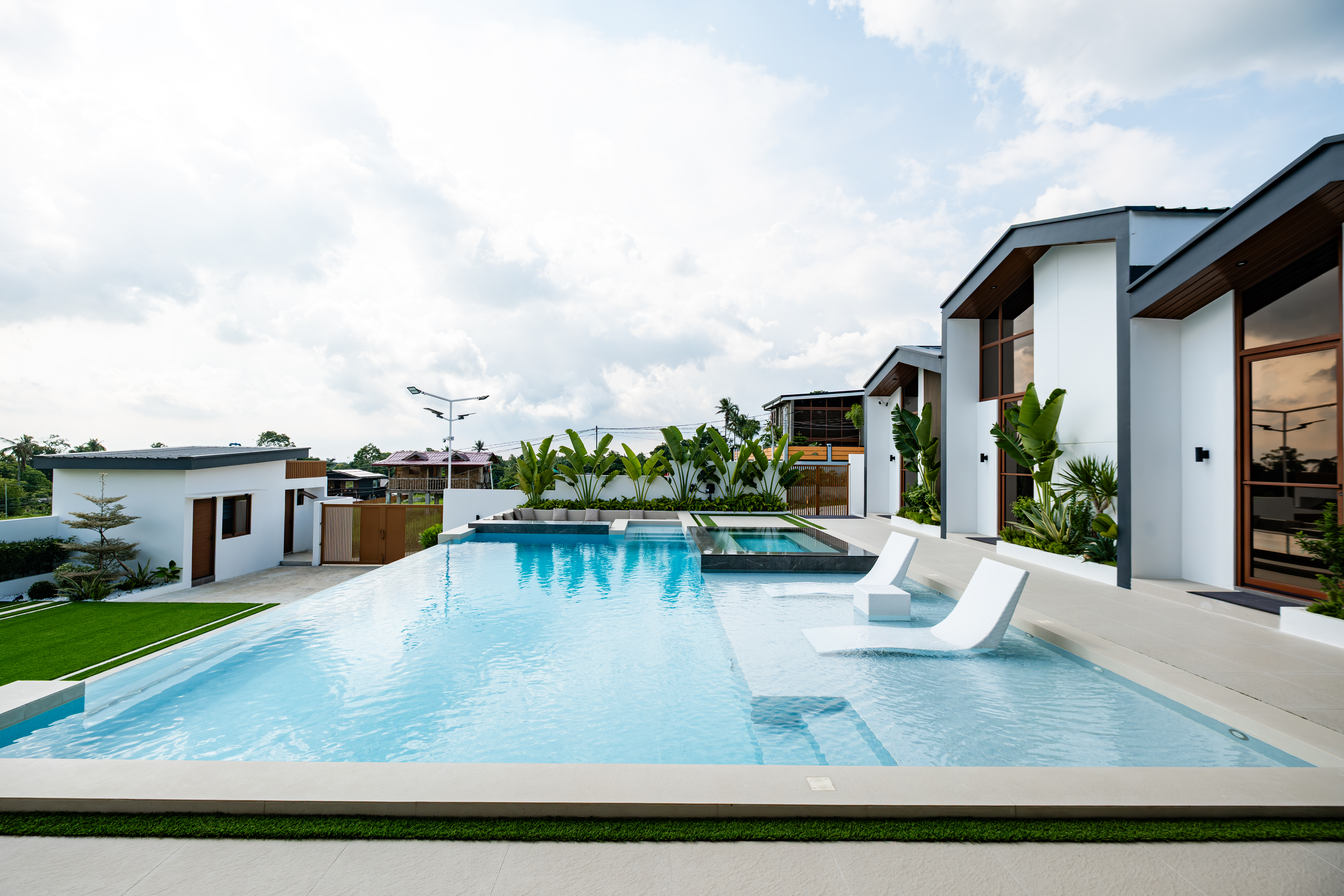 Pool loungers set in the shallow section of the infinity pool.