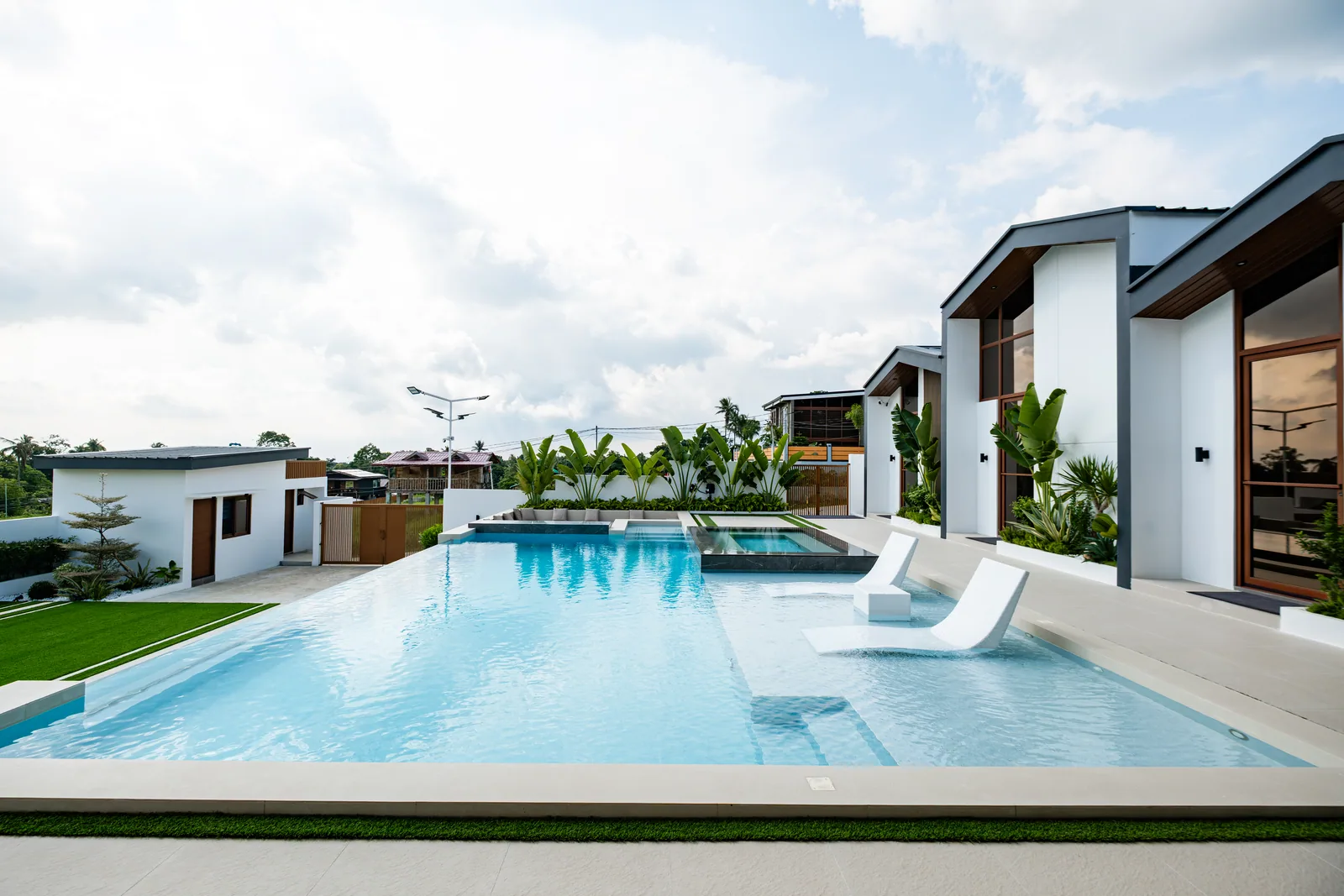 Pool loungers set in the shallow section of the infinity pool.
