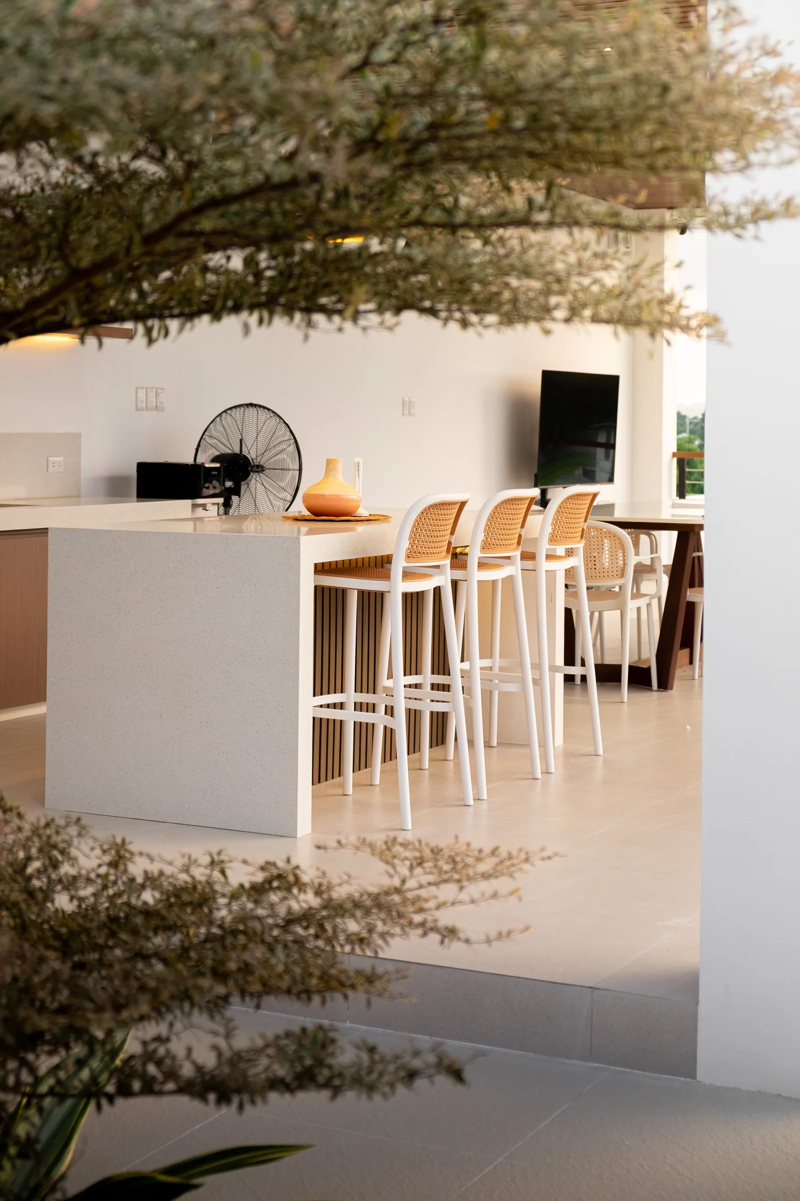 Text: Landscaped courtyard leading to the open-air kitchen and dining pavilion at The Kasiden Private Resort.