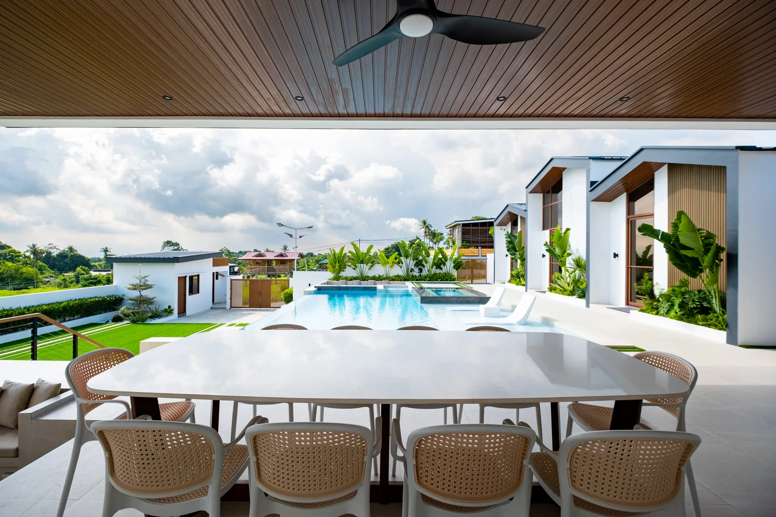 Alfresco dining area overlooking the infinity pool, villas, and scenic surroundings at The Kasiden Private Resort in Alfonso, Cavite.