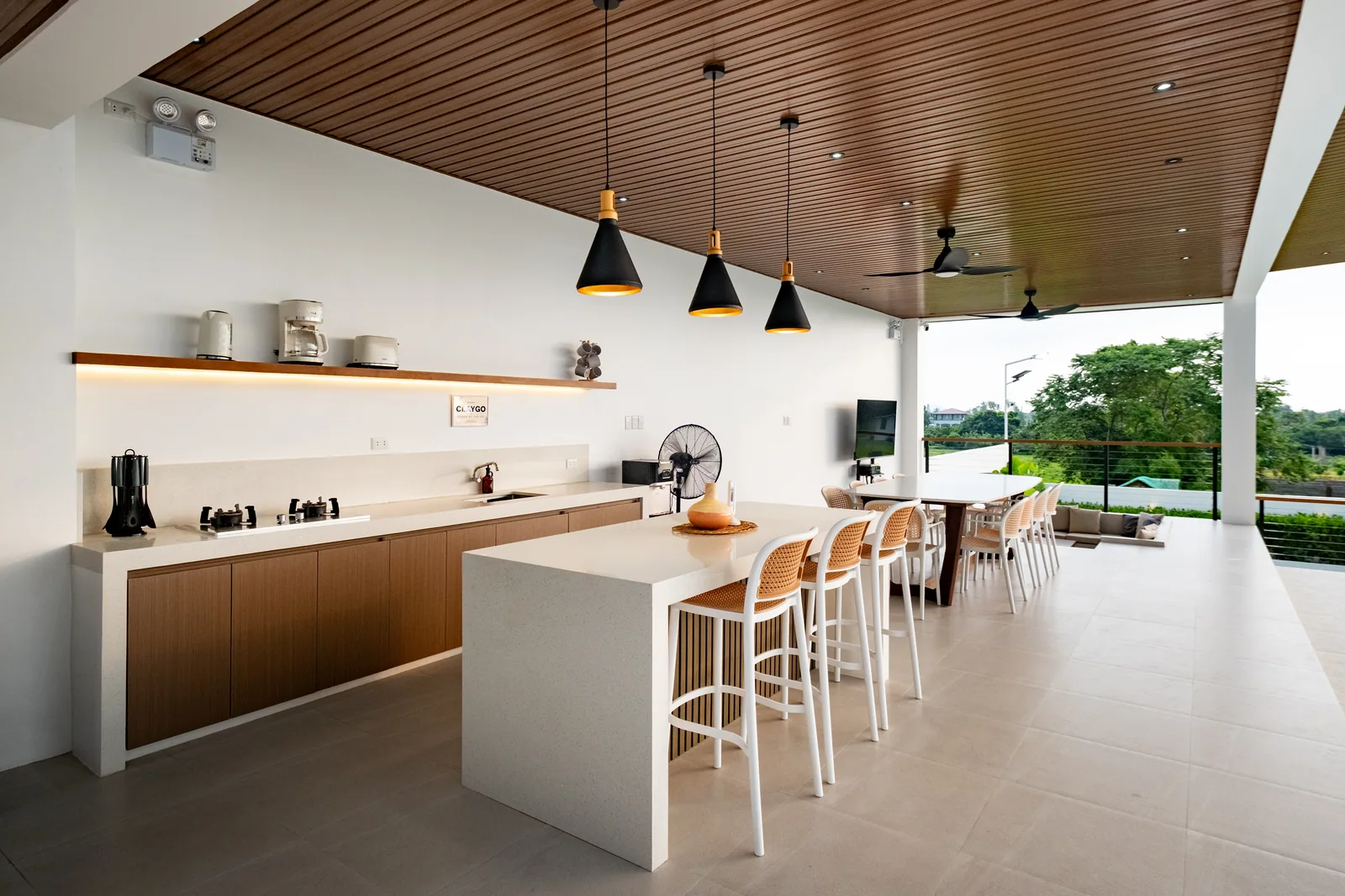 Spacious open-air dining pavilion featuring a fully equipped kitchen, dining tables, and scenic nature views at The Kasiden Private Resort in Alfonso, Cavite.
