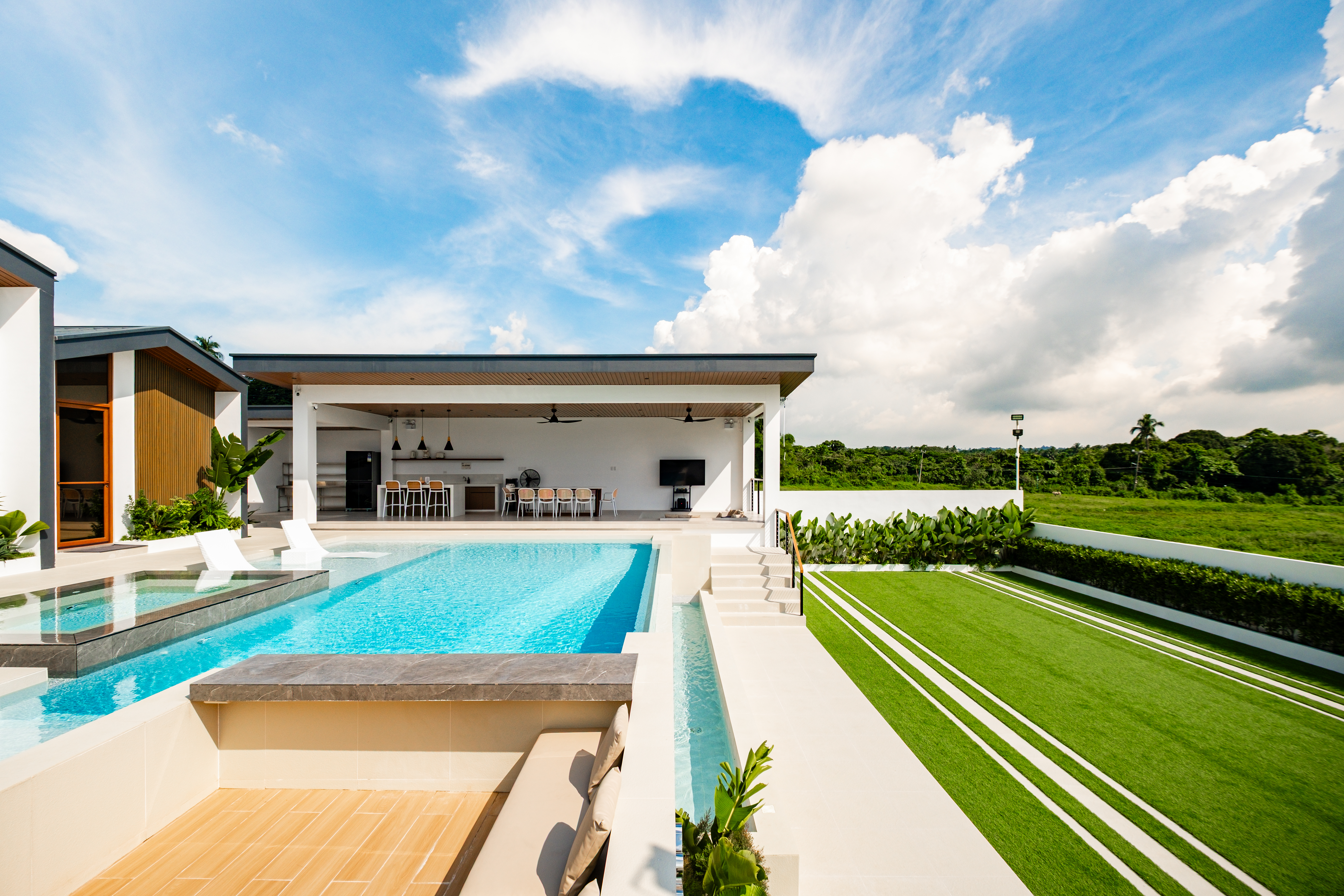 Infinity pool overlooking the large activity lawn at The Kasiden Private Resort.