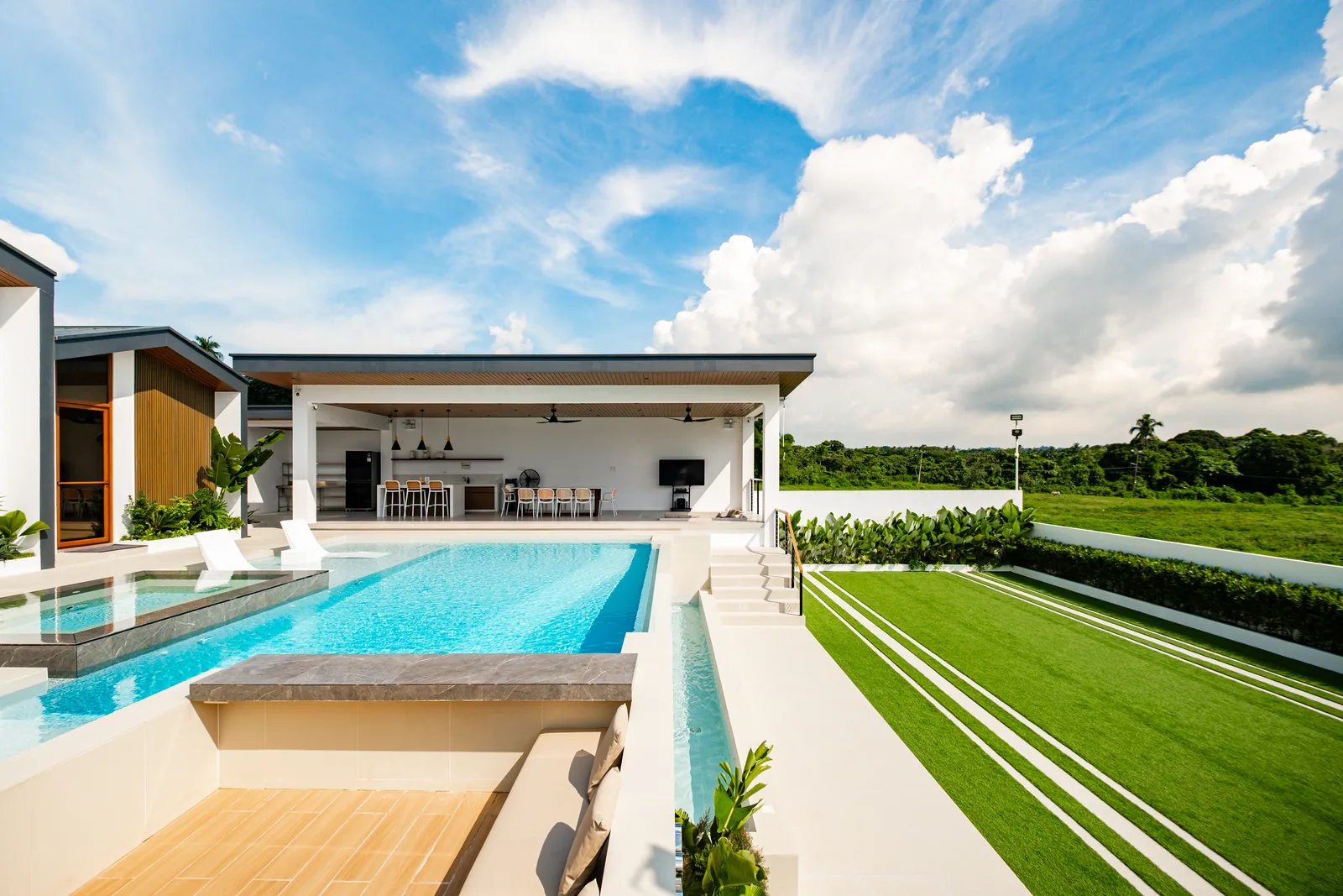 Infinity pool overlooking the large activity lawn at The Kasiden Private Resort.