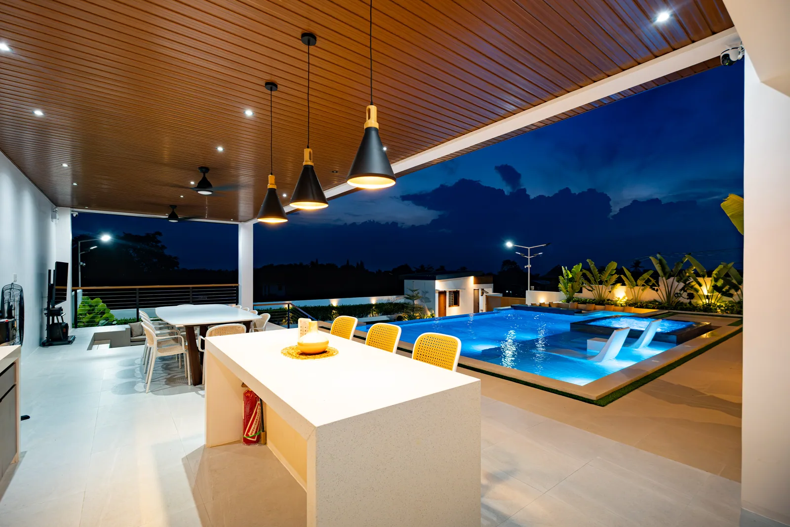 Illuminated gazebo, dining pavilion, and infinity pool at night at The Kasiden Private Resort.