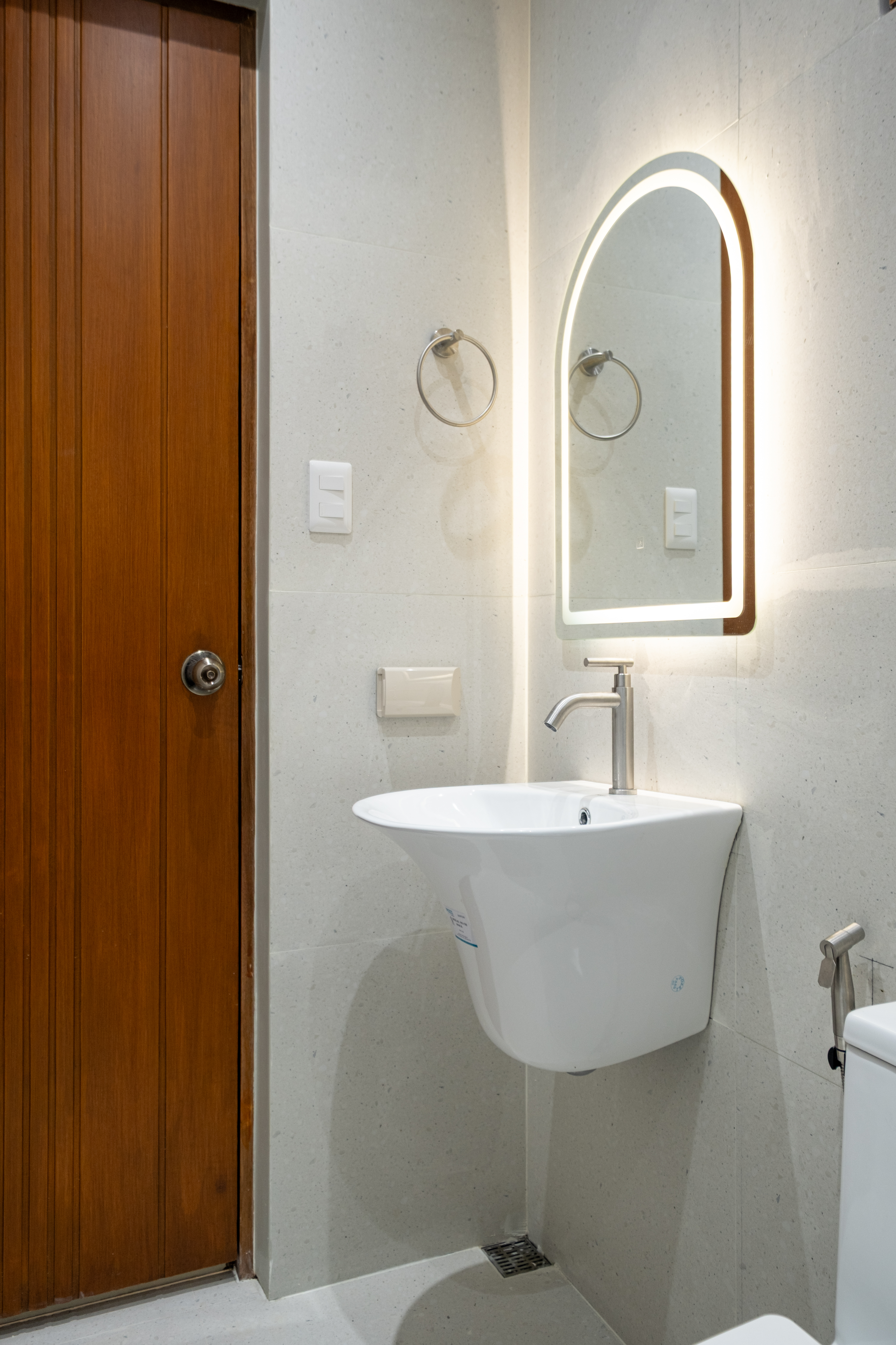 Contemporary bathroom vanity with illuminated mirror, modern sink, and premium finishes at The Kasiden Private Resort.