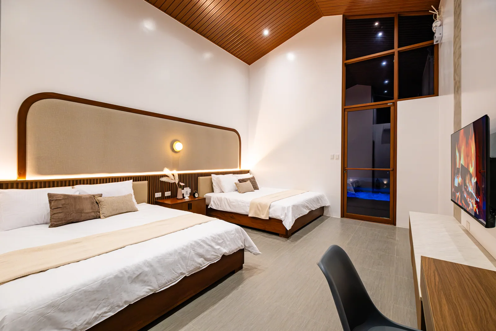 Warm and inviting family suite with two king-size beds and elegant evening lighting at The Kasiden Private Resort in Alfonso, Cavite.